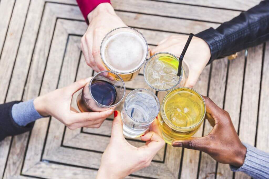 An array of glass cups with 6 different natural beverages preserved with IFF GUARDIAN® AQUAROX™