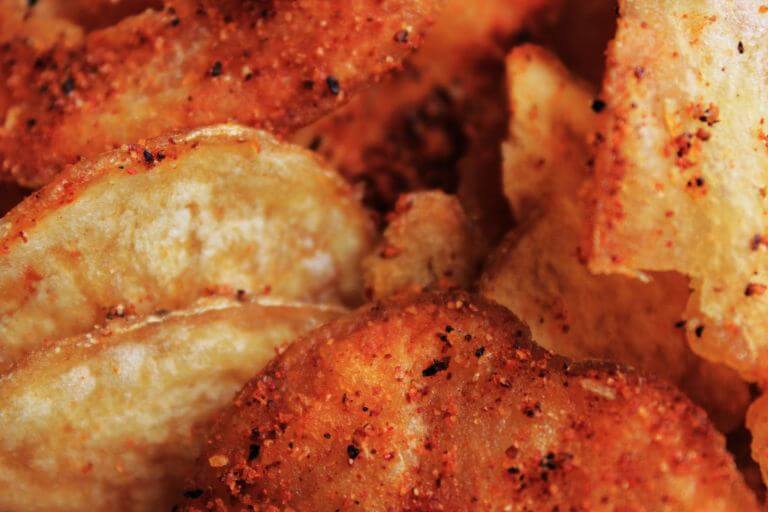 Macro shot of barbecue ships with seasoning and spices on them