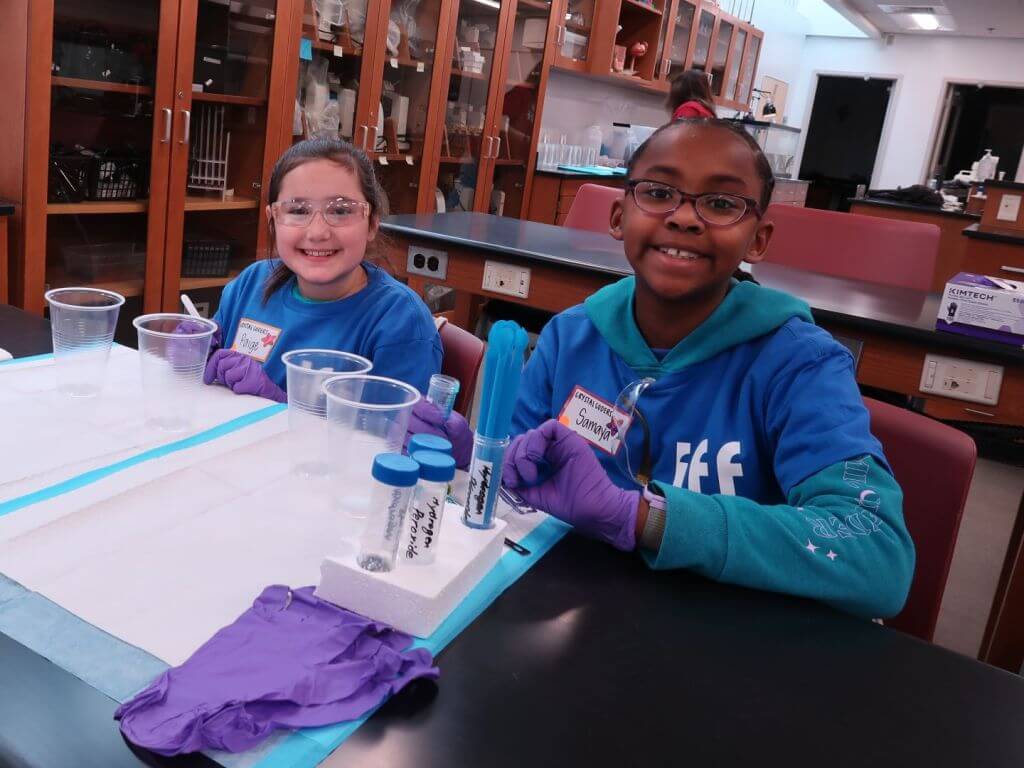 Girl Scouts doing science experiments at IFF.
