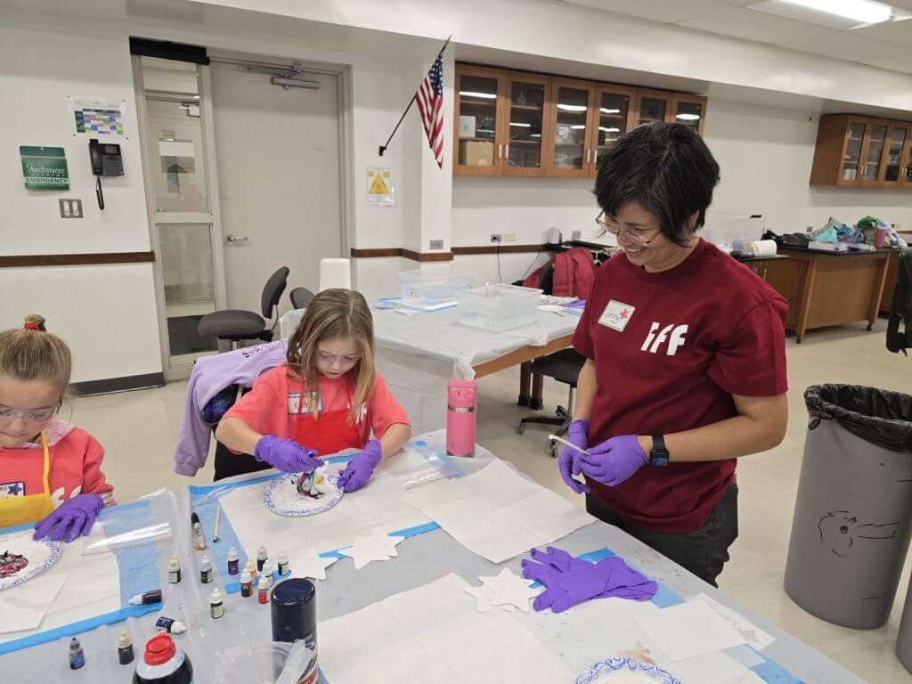 Girl Scouts and an IFF scientist doing a Science experiment.