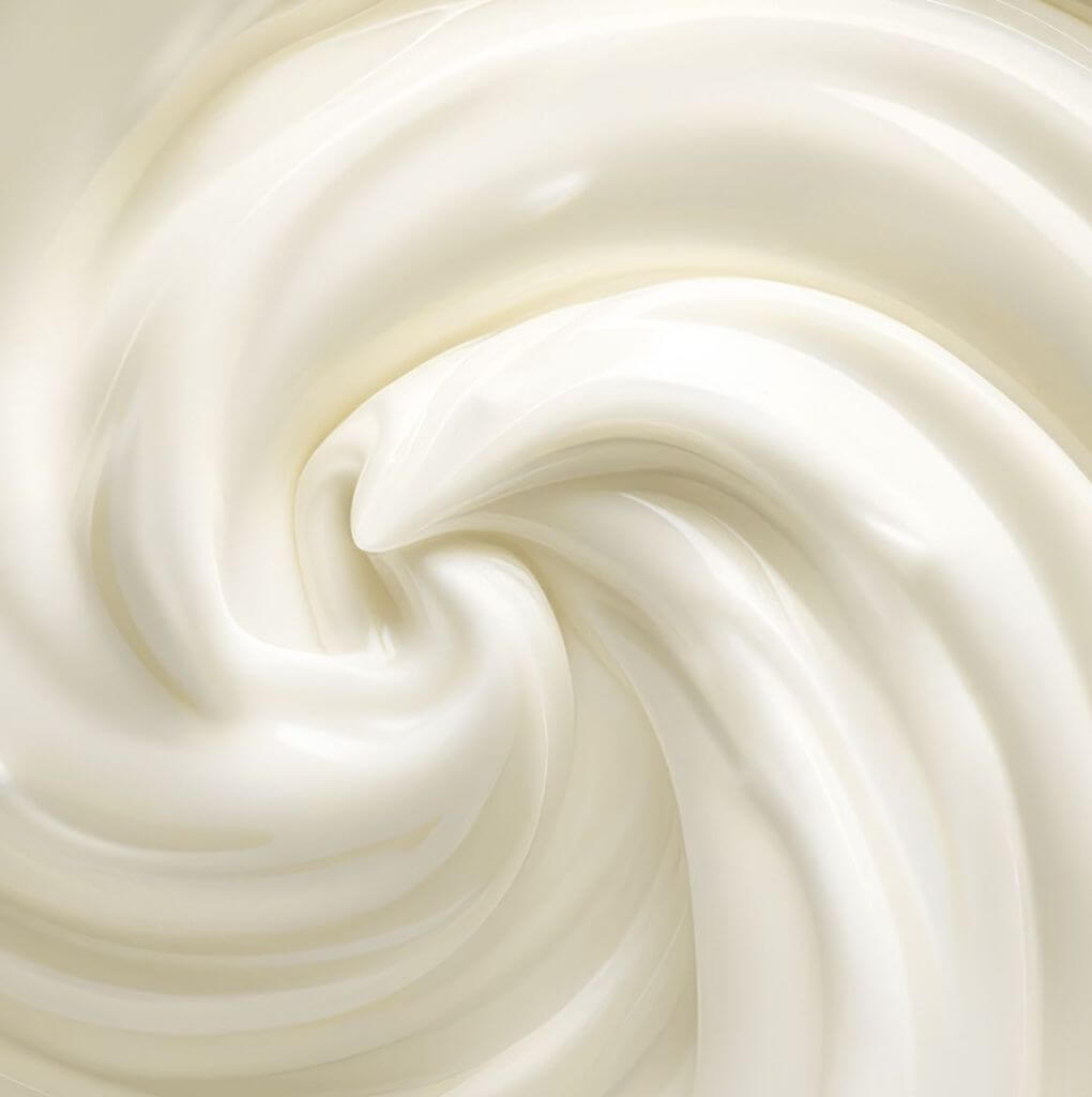 Macro, close-up shot of a giant swirl of vanilla-flavored yogurt