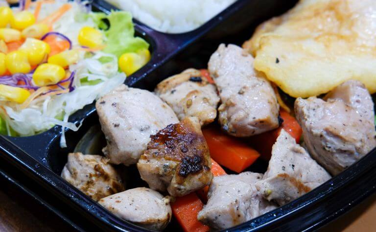 Macro shot of a ready to eat meal with chicken that has smoke and grill flavor