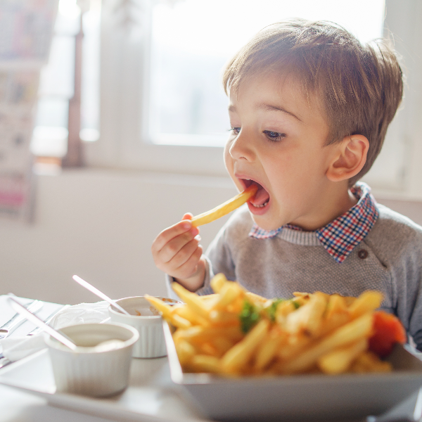 Boy eating French fries