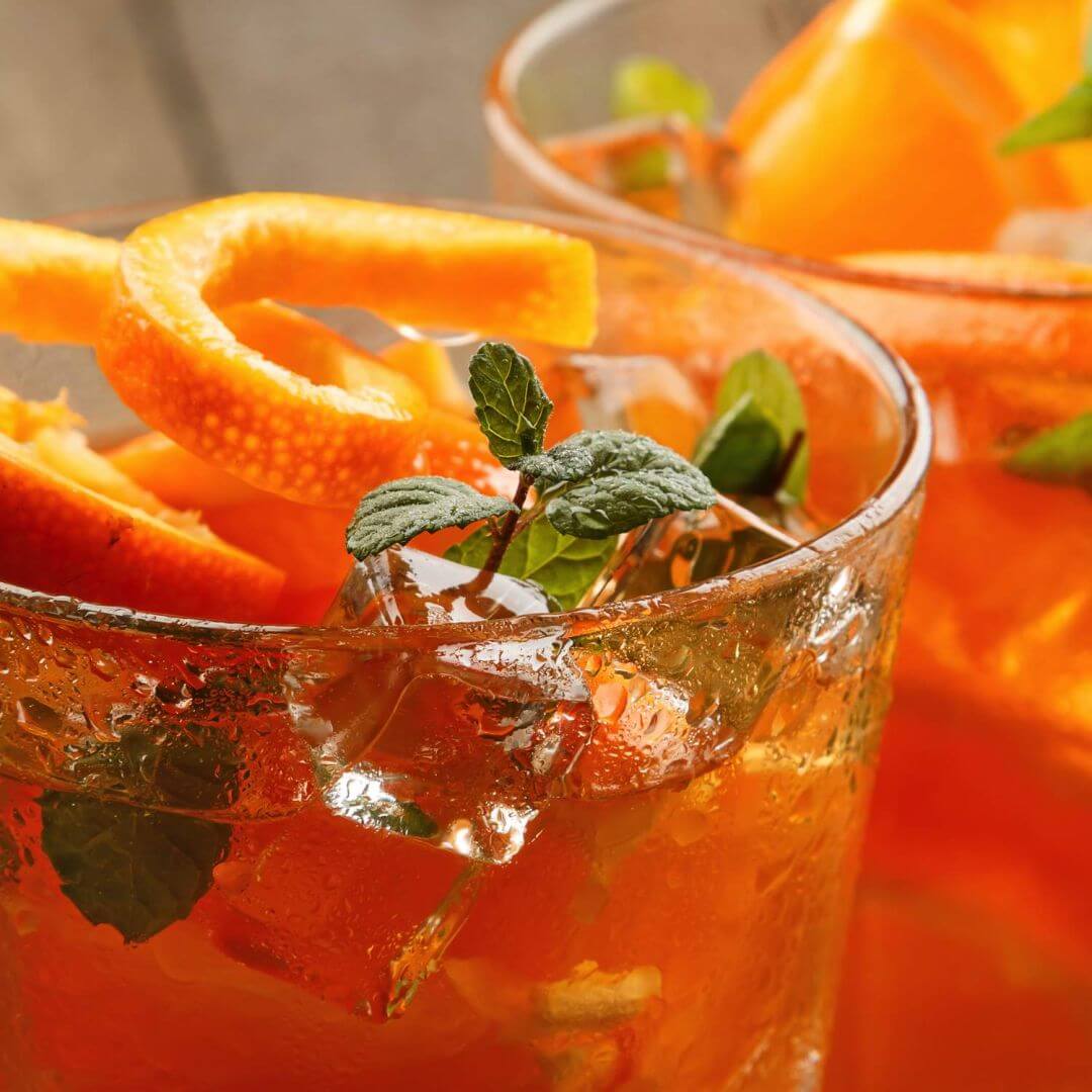 An array of glass cups with 6 different natural beverages preserved with IFF GUARDIAN® AQUAROX™