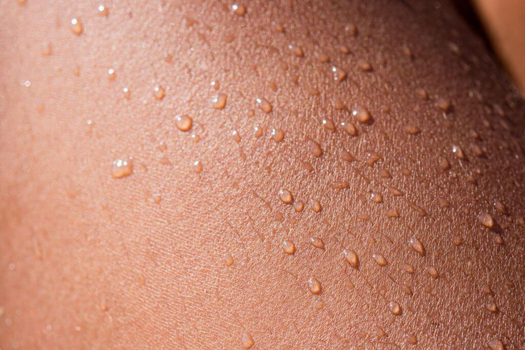 Close-up of skin with water droplets.