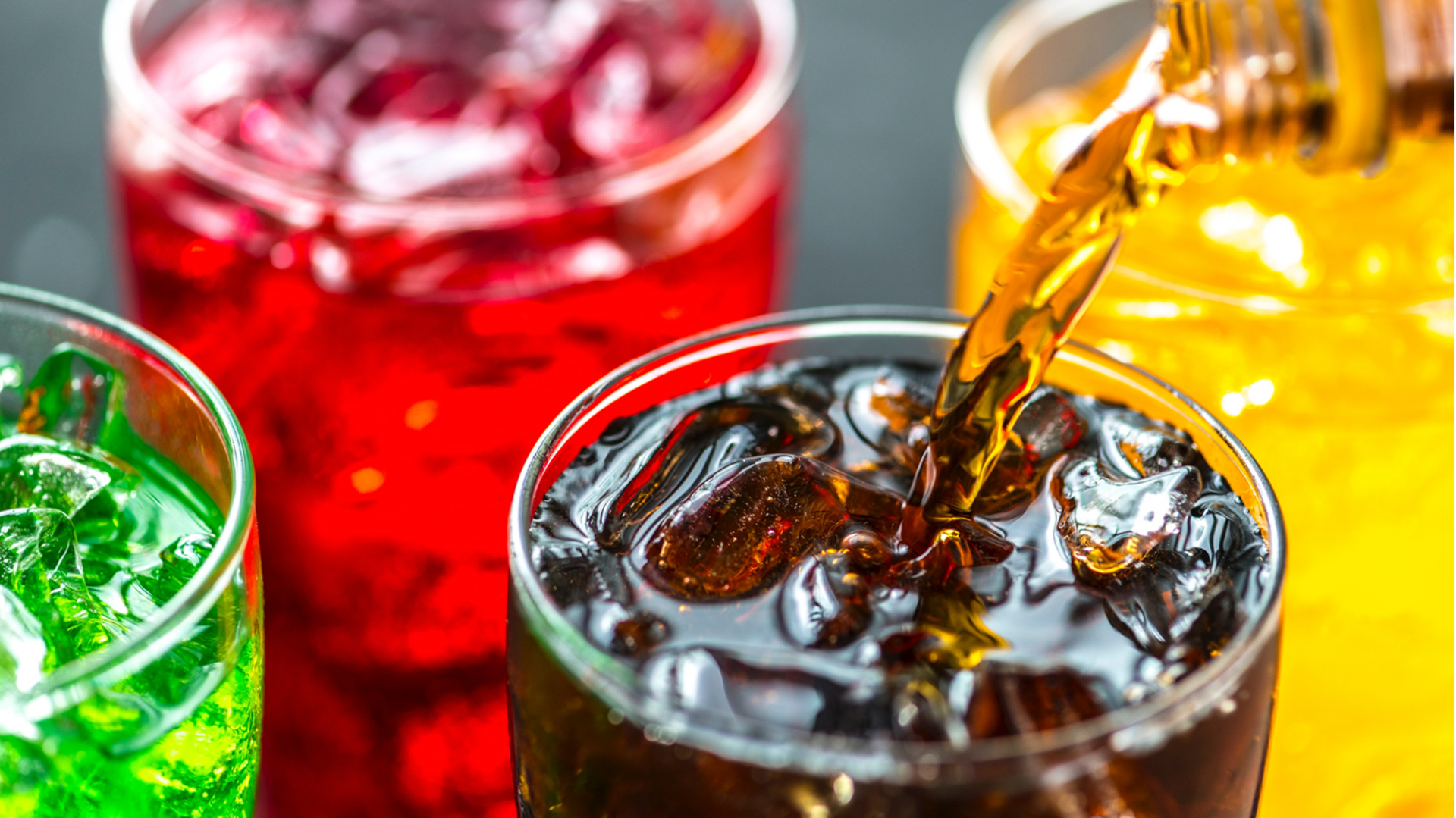 Brightly colored iced beverages in glasses